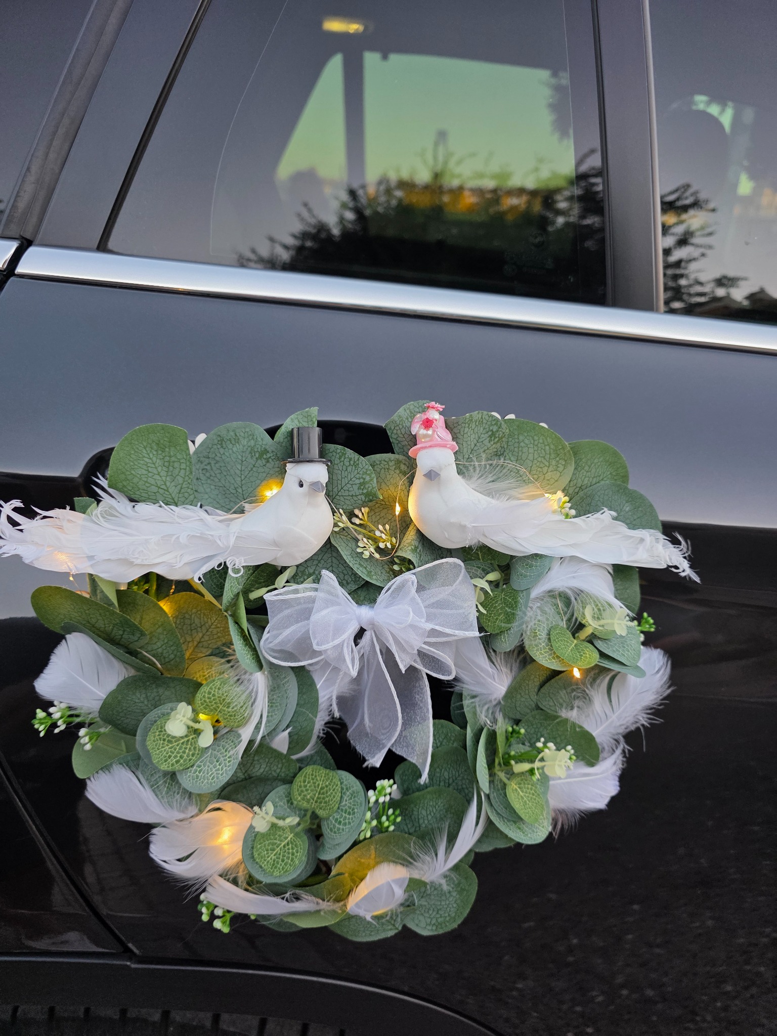 Detalle de aves blancas del adorno trasero de la creación Primer vuelo